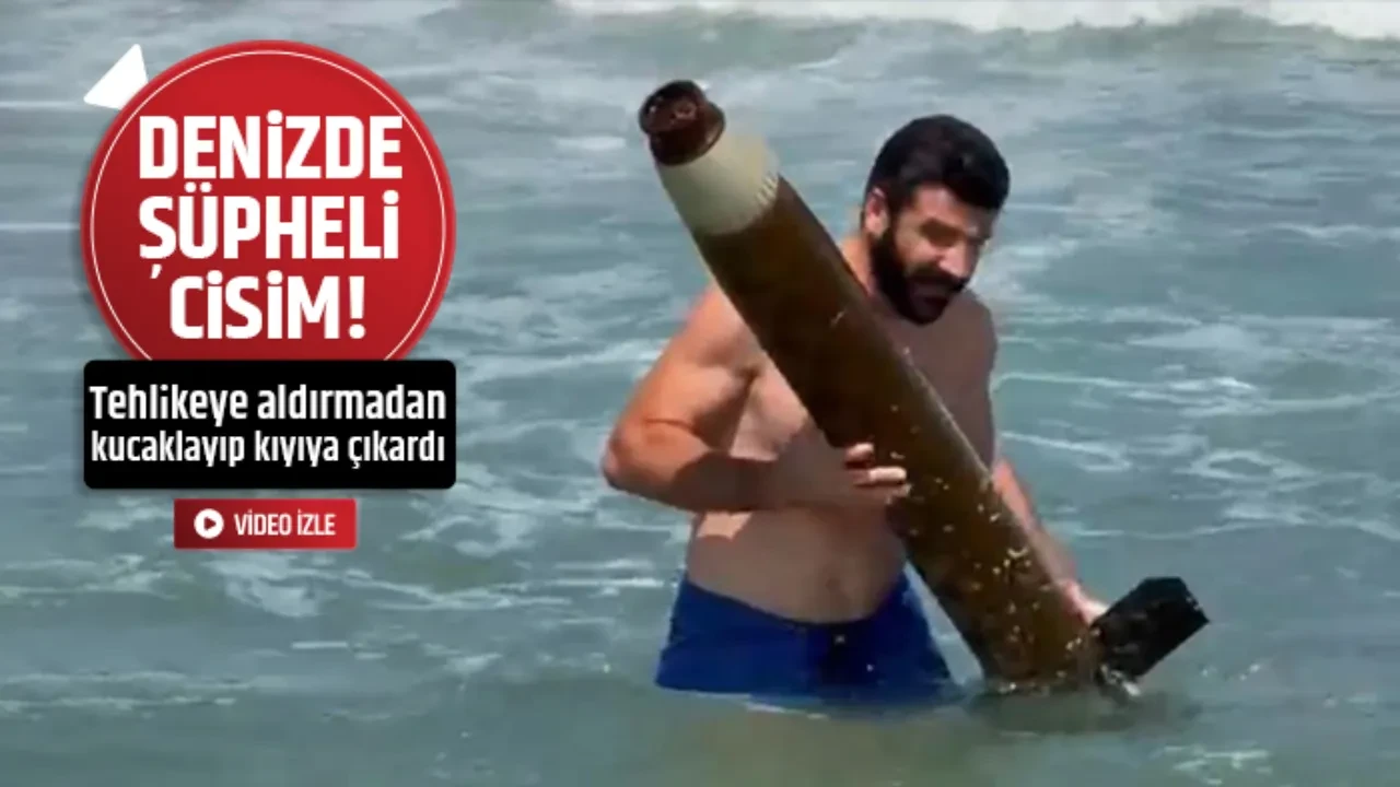 DENİZDE BULDUĞU FÜZE PARÇASINI KIYIYA ÇIKARDI