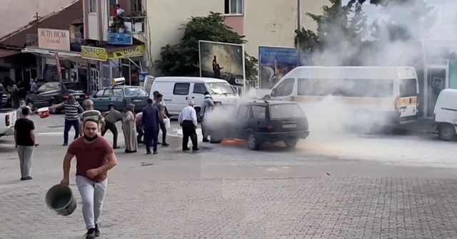 Yanan otomobili söndürmek için kovalarla su taşıdılar