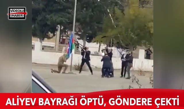 Aliyev, Azerbaycan bayrağını öperek göndere çekti