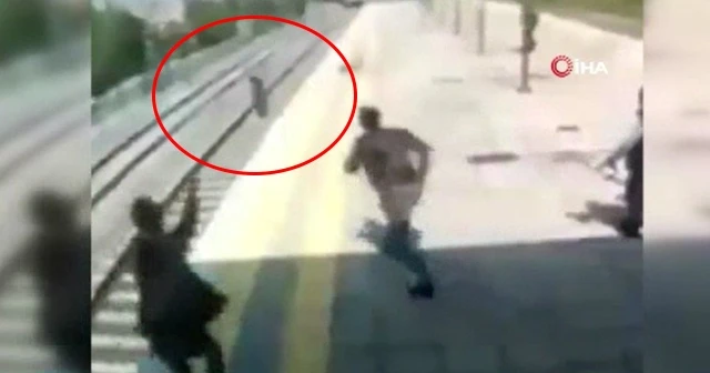 Trenin önüne atlayıp intihara kalkışan kadını kurtardı