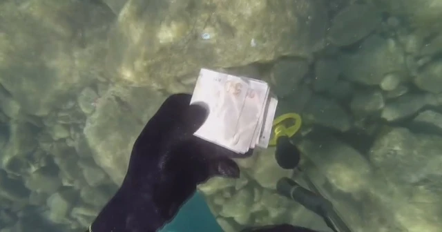 Denizde bulduğu para dolu çantayı sahibine gönderdi