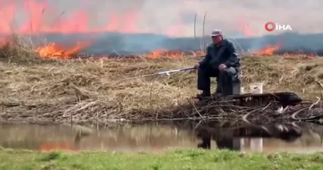 Yangına rağmen balık tutmaya devam etti
