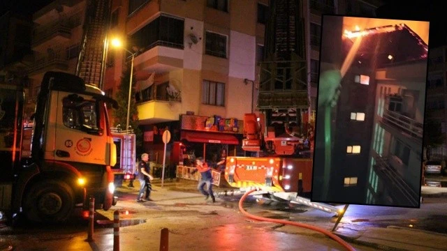 Yanan binaya karşı balkondan hortumla müdahale