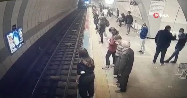 Raylara atladı, trenin altında burnu bile kanamadan çıktı